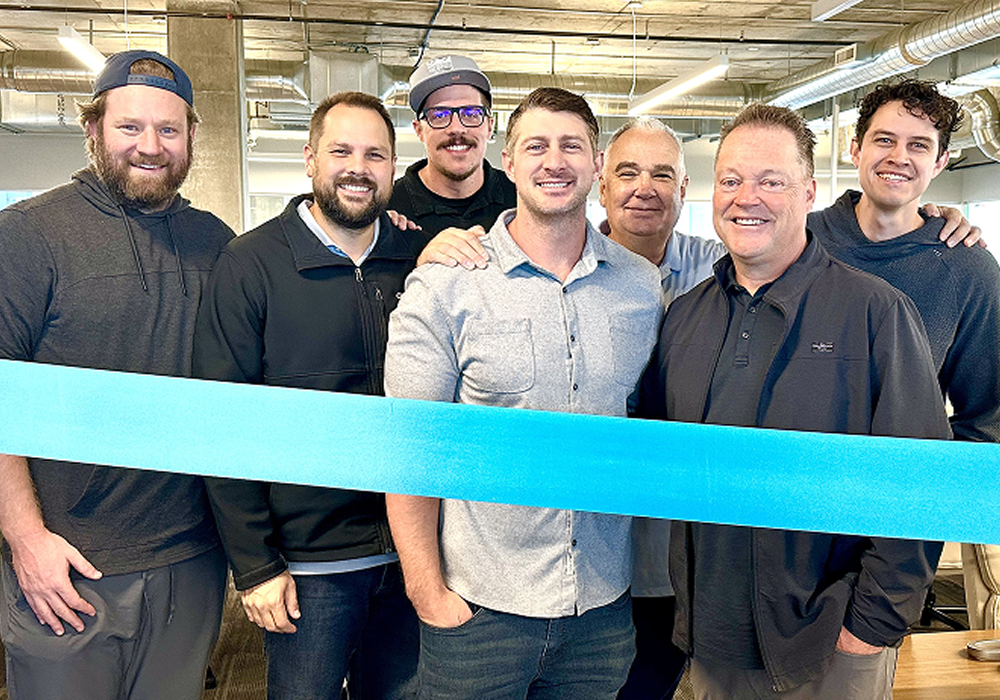 Multifamily Reputation Management Team Celebration – Opiniion: Resident Insight that Drives Property Success Team celebrating multifamily reputation management success in office setting - Opiniion: Resident Insight that Drives Property Success