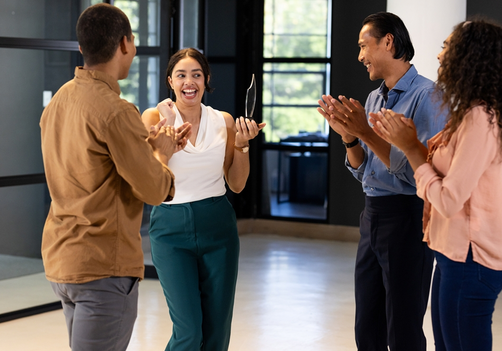 Group celebrates a Resident Choice Award recipient holding a trophy - Opiniion: Resident Insight that Drives Property Success